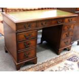 A Reproduction Mahogany Pedestal Desk, with green leather inset, 123cm by 61cm by 78cmThe top with a