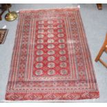 Bukhara Rug, the claret field with three columns of guls enclosed by narrow borders,1.99 by 94cm,