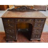 An Early 20th Century Carved Oak Kneehole Desk, 106cm by 52cm by 98cm