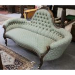 A Victorian Mahogany Framed Button Back Sofa, the shaped back above inwardly curved arms over a