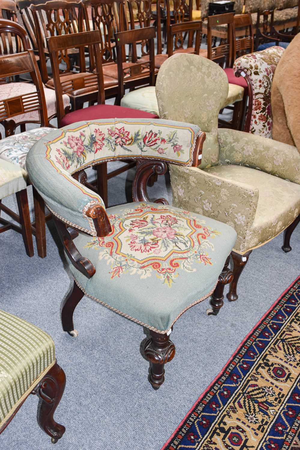 A Victorian Horseshoe Back Chair, with carved mahogany frame and needlework upholstery, moving on