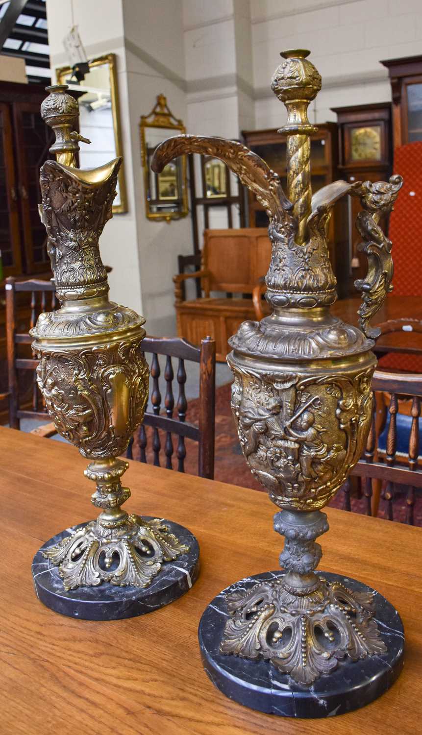 A Pair of Gilt Metal Ewer Form Table Lamps, on circular marble bases, 70cm high (a/f)