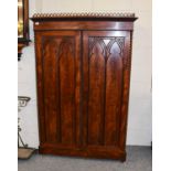 A Mahogany Bookcase Cupboard, with Gothic decoration, 115cm by 51cm by 173cm