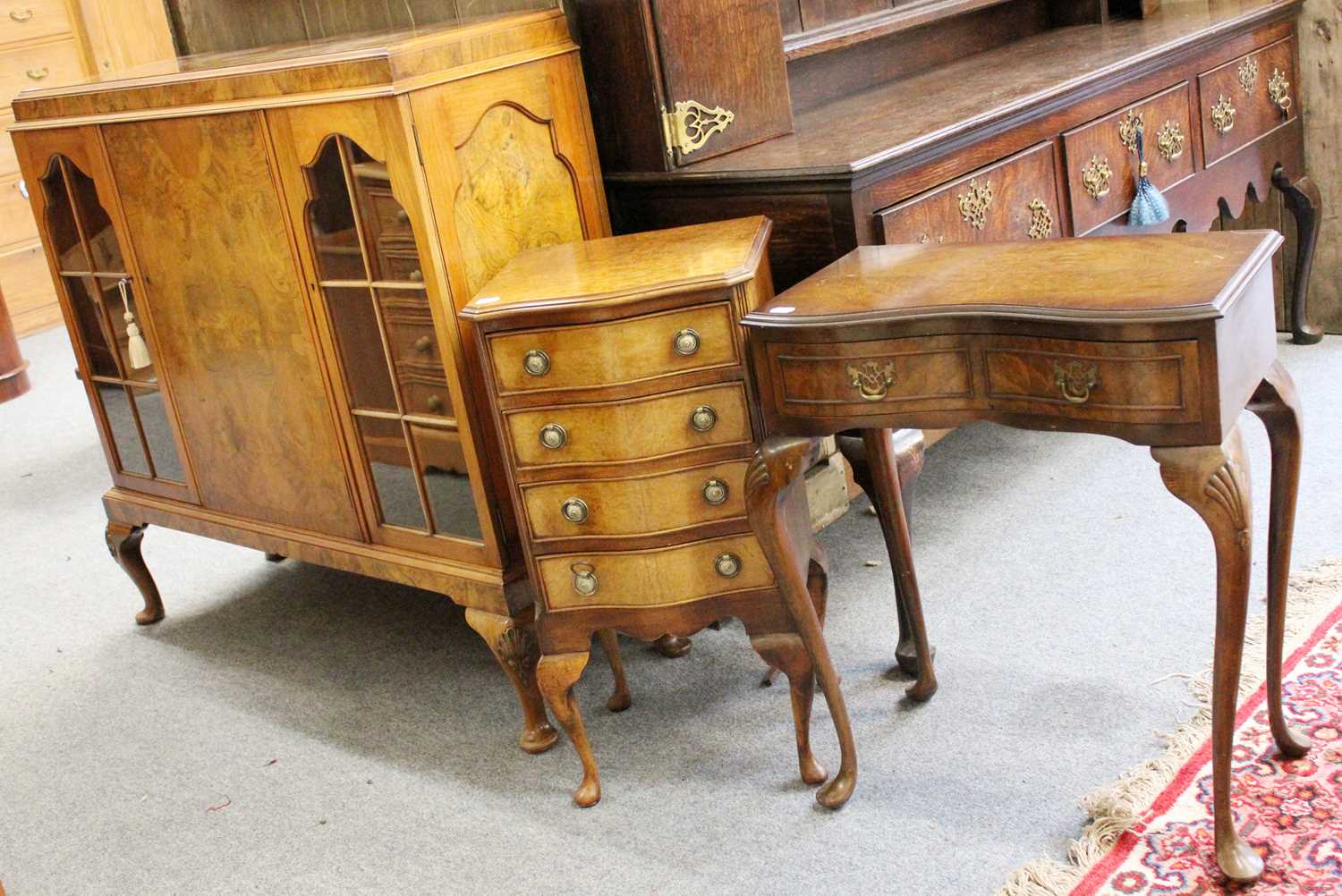 A Small Group of Reproduction Walnut Furniture, comprising: a serpentine front four height chest