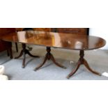 A Mahogany Triple Pillar D End Dining Table, the down swept reeded legs terminating in brass paw