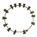 A Bamileke Chief's Necklace, Cameroon, as a steel circlet set with fifteen bronze masks, 39cm