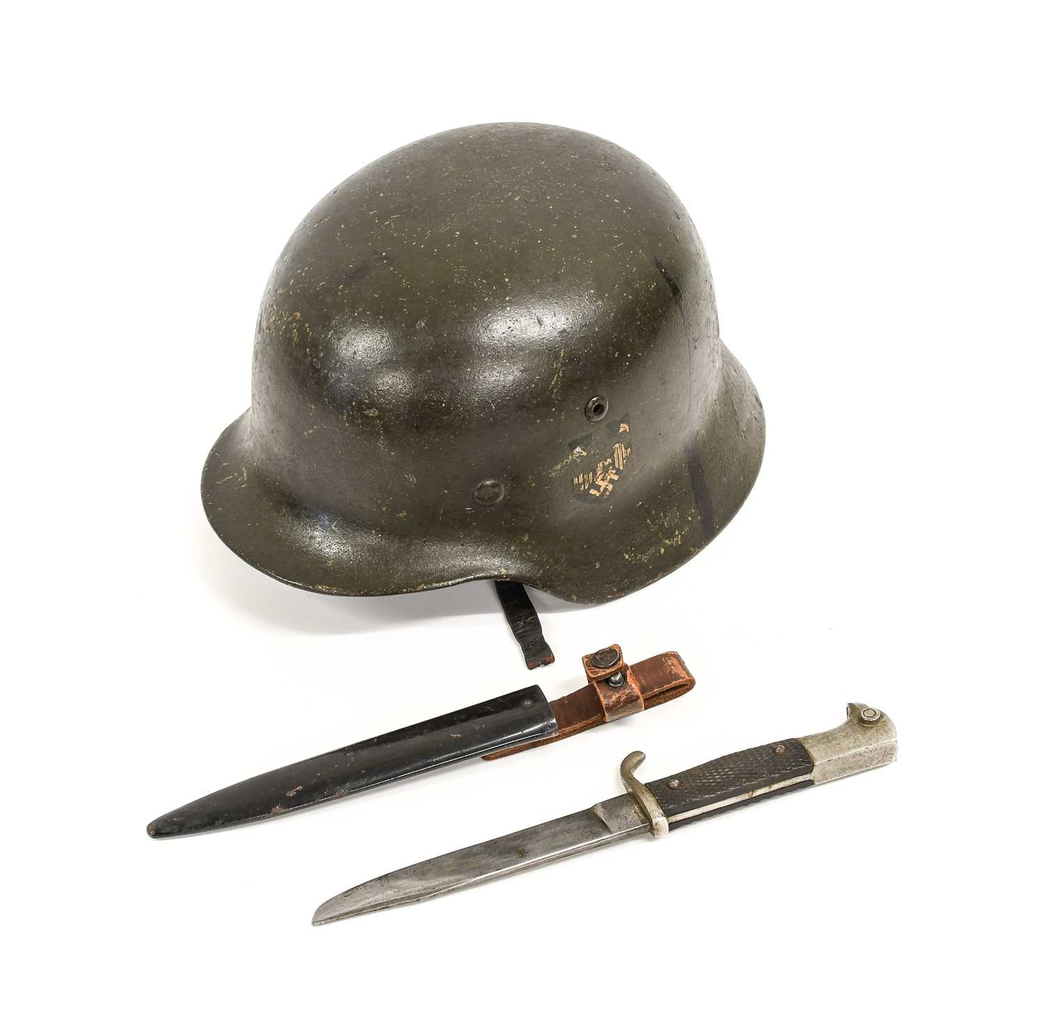 A Second World War Geman M35 Combat Helmet, with dark green finish, later Heer decal, folded rim,