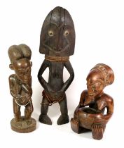 A Baule Carved Wood Fertility Figure, Ivory Coast, standing with double lobed combed coiffure, heart