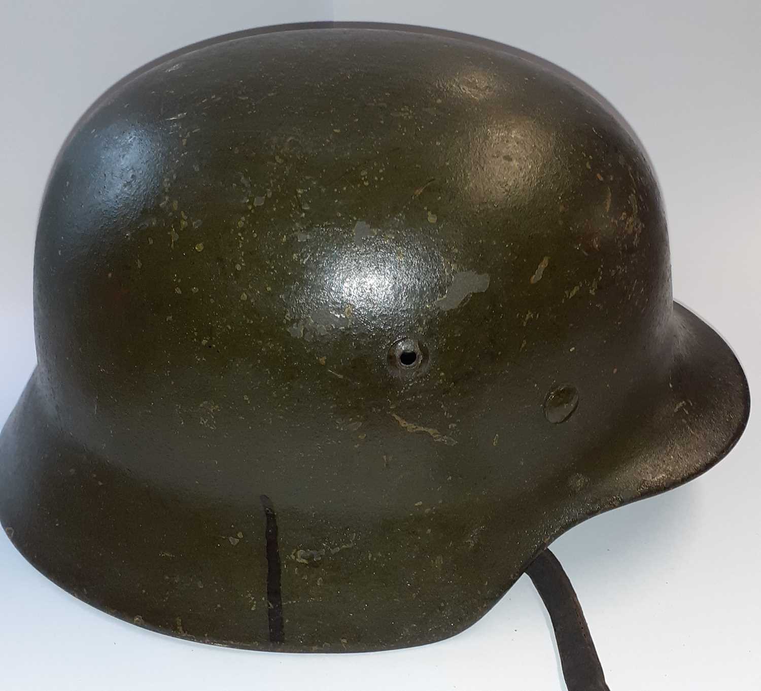 A Second World War Geman M35 Combat Helmet, with dark green finish, later Heer decal, folded rim, - Image 9 of 9
