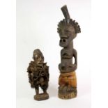 A Songye Power Figure (Nkisi), DRC, carved as a standing man with a deer horn projecting from the