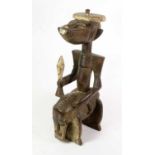 A Senufo Carved Wood Divination Figure of Bandeguele, as a stylised man seated astride a horse and