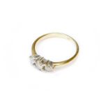 A Diamond Three Stone Ring, stamped '750' and '18K', finger size L1/2The ring is in good