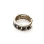 A Sapphire and Diamond Half Hoop Ring, stamped 'K18', finger size NNB: One sapphire deficient.