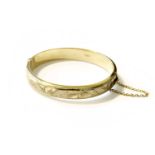 A 9 Carat Gold Hinged Bangle, inner measurements 6.1cm by 5.5cmGross weight 14.9 grams.