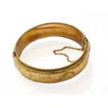 A 9 Carat Gold Hinged Bangle, inner measurements 6.1cm by 5.6cm (a.f.)Gross weight 28.5 grams.