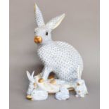 A Herend Porcelain Model of a Hare, blue ground and on a scroll moulded base, printed mark, 30.