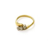 An 18 Carat Gold Diamond Three Stone Twist Ring, finger size LGross weight 4.1 grams.