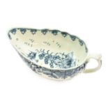 A Worcester Porcelain Sauceboat, circa 1775, of fluted form, painted in underglaze blue with the