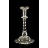 A Glass Taperstick, circa 1780, on a faceted stem and foot15cm highTypical minor wear. Small chip to