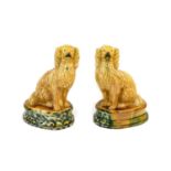 A Pair of Majolica Seated Spaniels, circa 1870, naturalistically modelled sitting on an oval base