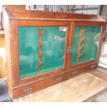 Glazed oak two-door wall cabinet with fittings for display antique rifles with drawers below