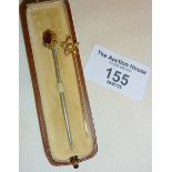 Two antique stick pins in case - a 15ct gold star shape with pearls, and another 9ct set with red