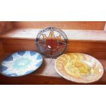 Two decorative platters and a stained glass hanging