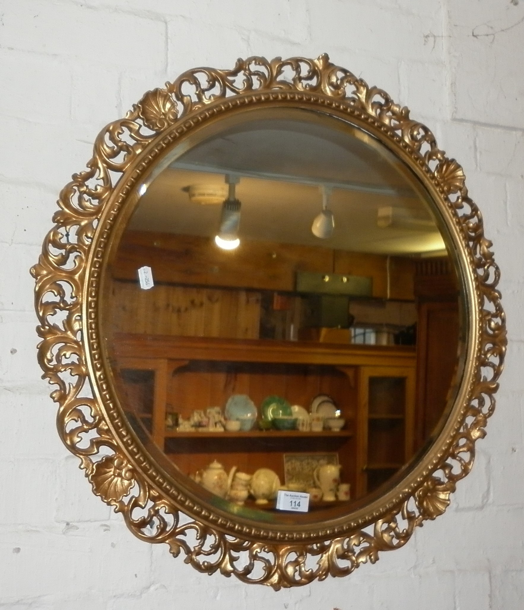 Round wall mirror with gilded frame