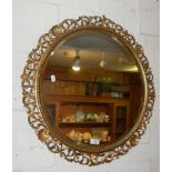 Round wall mirror with gilded frame