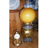 Oil lamp with speckled lustrous reservoir (converted), and a clock under a dome by Kern