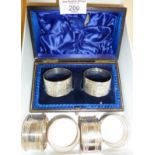 Set of four hallmarked Sterling silver napkin rings, and an antique pair with engraved decoration in