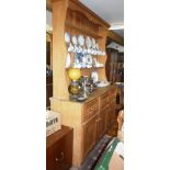 Old pine dresser with three shelves to top above base with three drawers and three cupboard doors,