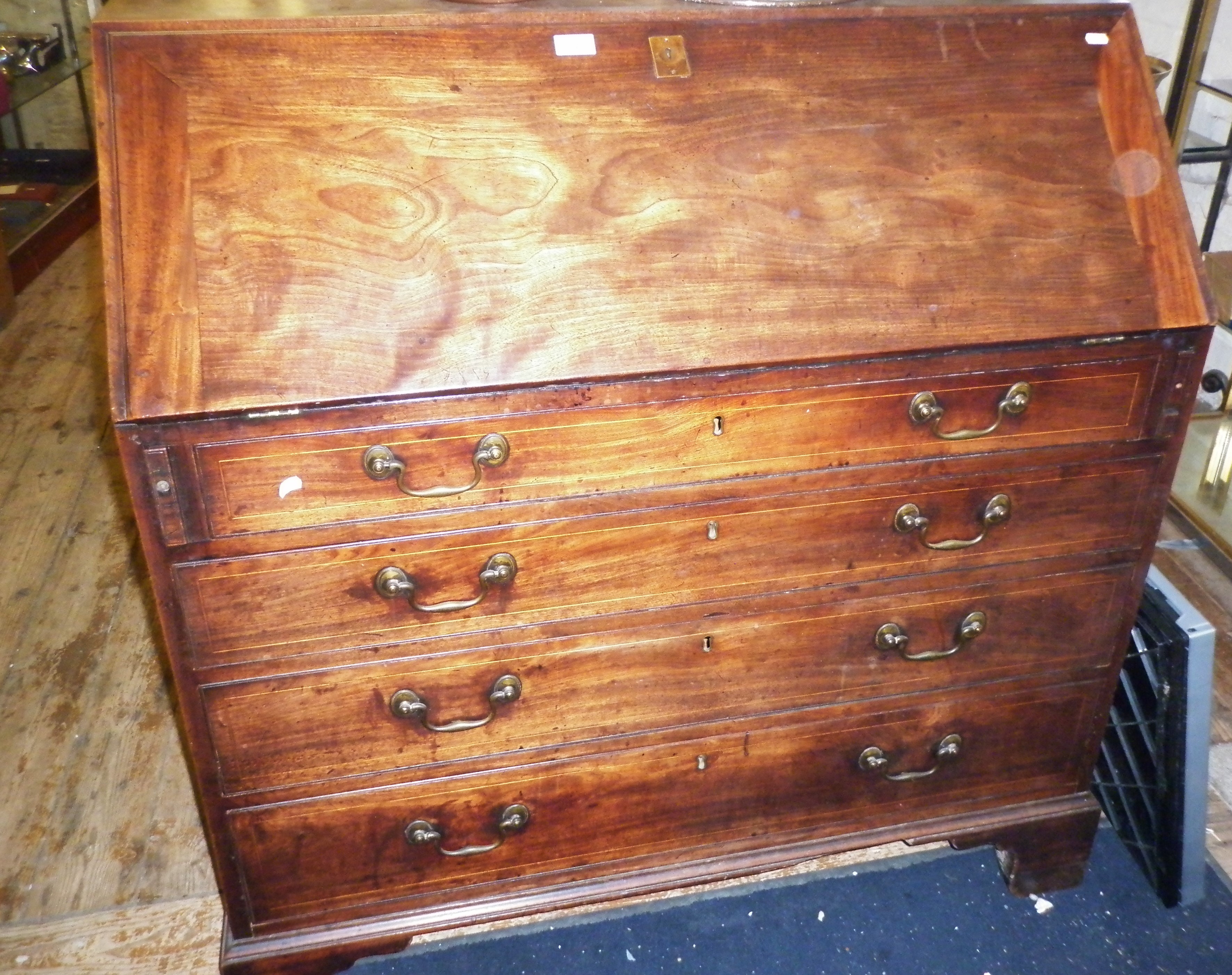 Georgian mahogany bureau with four graduated drawers on bracket feet