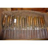 18 old woodworking chisels in leather roll, most named