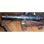 Large and heavy cast iron cannon on oak stand, approx. 39cm long