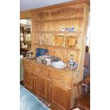 Old pine dresser with three shelves to top above base with three drawers and three cupboard doors,