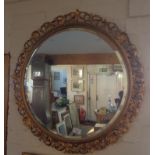 Round wall mirror with gilded frame