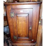 Small mid 19th c. mahogany corner cupboard with single door enclosing shaped shelves