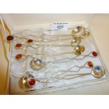 Continental silver set of 6 plus one larger iced tea or long honey spoons, with amber finials