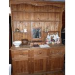 Old pine dresser with three shelves to top above base with three drawers and three cupboard doors,