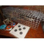 A wire squirrel trap, a mole trap, several rabbit wires, air gun pellets and targets