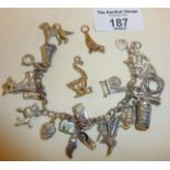 Sterling silver charm bracelet with many charms, most marked as 800 or higher silver