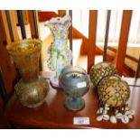 Glass vase with wirework overlay, another similar and two decorative gourds having hanging cowrie