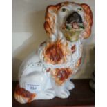 Victorian Staffordshire pottery spaniel with flower basket, 9" tall