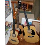 An Encore acoustic guitar, a Chantry similar and another