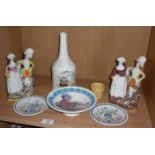 Two Staffordshire figure groups, three Poole Pottery dishes and a Copeland Spode wine bottle