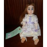 Reproduction hand painted bisque headed doll with human hair