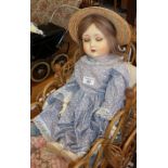A Schoenau & Hoffmeister bisque headed open mouthed doll with sleeping eyes and ball jointed