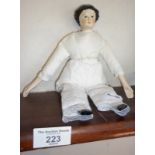 Antique china headed doll with painted hair and features with flat top curly hair, china arms and
