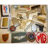 Various vintage lighters, souvenir spoons, silver ARP badge, etc.